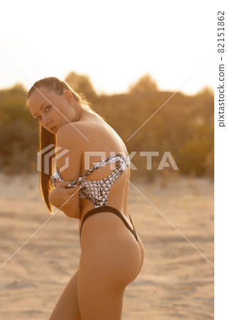 Gorgeous woman in swimsuit on shore 82151862