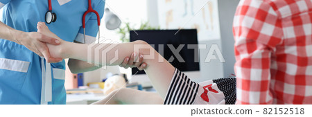 Traumatologist orthopedist examines child leg in medical office 82152518