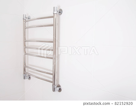 Modern stainless steel heated towel rail in the bathroom. Plumbing heating device, copy space for text Modern stainless steel heated towel rail in the bathroom. Plumbing heating device, copy space for text 82152920