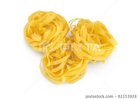 Raw tagliatelle pasta isolated on white background with clipping path and full depth of field. Top view. Flat lay 82153928