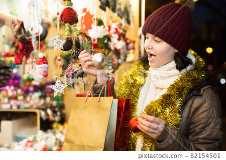Charming teen girl with Christmas garlands Charming teen girl with Christmas garlands 82154501