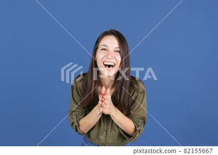 Cropped studio shot of laughing woman isolated over blue background, happiness Cropped studio shot of laughing woman isolated over blue background, happiness 82155667