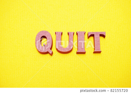 Top view Quit letters alphabet letters on Yellow background Top view Quit letters alphabet letters on Yellow background 82155720