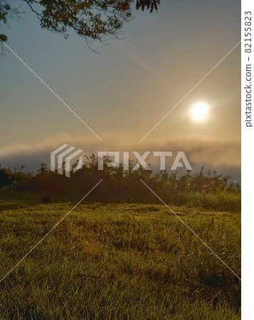 A landscape where the sun rises from the sea of clouds and the entire surface is dyed orange A landscape where the sun rises from the sea of clouds and the entire surface is dyed orange 82155823