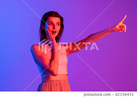 Studio shot of young Caucasian girl isolated on purple, lilac color studio background. Concept of human emotions, facial expression, cosmetics, youth Studio shot of young Caucasian girl isolated on purple, lilac color studio background. Concept of human emotions, facial expression, cosmetics, youth 82156431