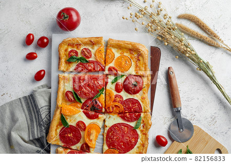 Delicious homemade square pizza with vegetables on white Delicious homemade square pizza with vegetables on white 82156833
