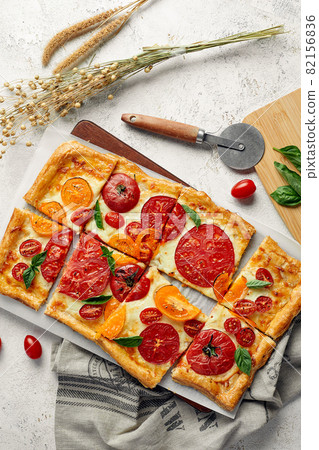 Delicious homemade square pizza with vegetables on white Delicious homemade square pizza with vegetables on white 82156836