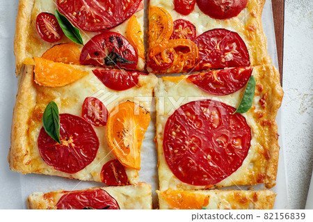 Delicious homemade square pizza with vegetables on white Delicious homemade square pizza with vegetables on white 82156839