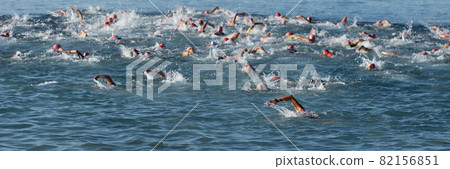 Large group of people in swimming at triathlon 82156851