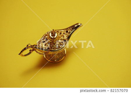 golden magic lamp with space copy on yellow background golden magic lamp with space copy on yellow background 82157070