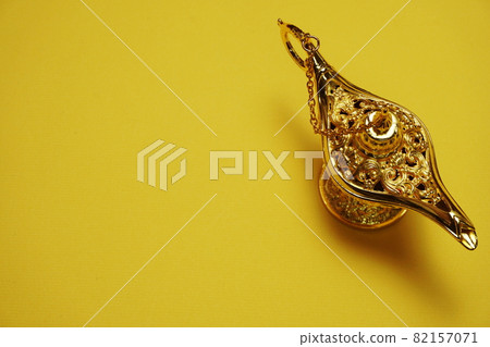 golden magic lamp with space copy on yellow background golden magic lamp with space copy on yellow background 82157071