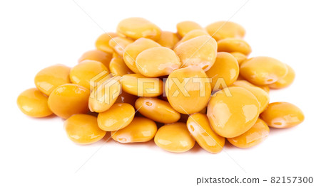 Pickled yellow lupine beans isolated on white background. Tournus, preserved lupinus. 82157300