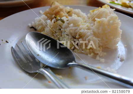 Leftover rice on dish Leftover rice on dish 82158079