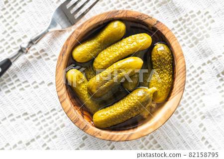Small pickles. Marinated pickled cucumbers in wooden bowl. Small pickles. Marinated pickled cucumbers in wooden bowl. 82158795