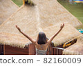 The image behind the women raise their arms looked at the  wooden raft on the water at Resort Wangnokkaew Park View Kanchanaburi , Thailand 82160009