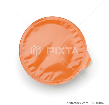 Top view of disposable plastic sauce cup with blank orange foil cover Top view of disposable plastic sauce cup with blank orange foil cover 82160820