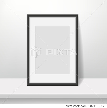 Realistic frame on wall background. Blank framed picture or poster mockup, dark plastic border with paspartu, vertical a4 photo format, interior design accessory, vector concept 82161147