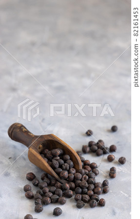 Raw Black chickpea on the wooden scoop closeup Raw Black chickpea on the wooden scoop closeup 82161453