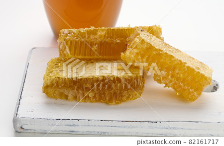 wax honeycomb with honey on a white board wax honeycomb with honey on a white board 82161717