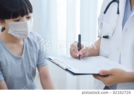 Focus on Hands, Doctor pediatrician writing information of girl patient on paper Focus on Hands, Doctor pediatrician writing information of girl patient on paper 82162726