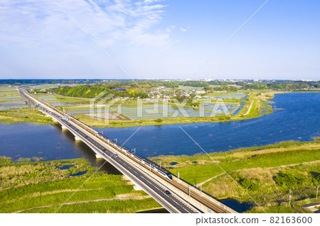 A photo shoot of Keisei Skyliner and National Route 464 crossing Inba-numa in Chiba Prefecture 82163600