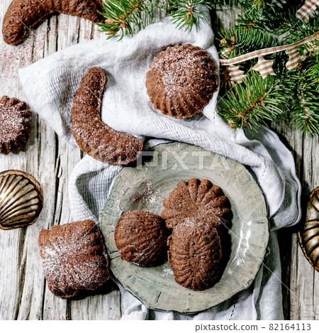 Christmas shortcrust cookies chocolate crescents with fir tree, molds, xmas decorations. Top view 82164113