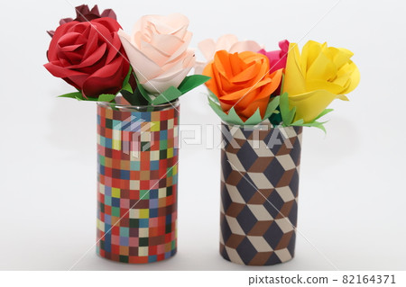 Handmade rose flowers made from origami are displayed in a beautiful vase Handmade rose flowers made from origami are displayed in a beautiful vase 82164371