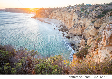 Stunning view over Praia do Camilo in Lagos, Algarve Portugal during the sunrise. Rocks, cliffs and formations in the ocean. Natural treasure. Portugal Stunning view over Praia do Camilo in Lagos, Algarve Portugal during the sunrise. Rocks, cliffs and formations in the ocean. Natural treasure. Portugal 82164580