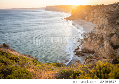 Stunning view over Praia do Camilo in Lagos, Algarve Portugal during the sunrise. Rocks, cliffs and formations in the ocean. Natural treasure. Portugal 82164637