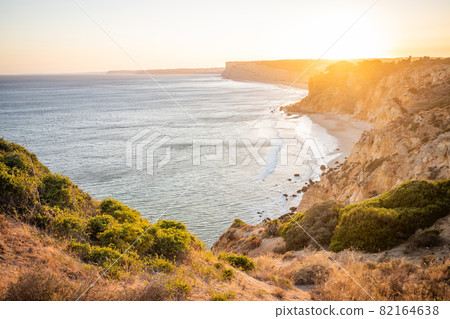 Stunning view over Praia do Camilo in Lagos, Algarve Portugal during the sunrise. Rocks, cliffs and formations in the ocean. Natural treasure. Portugal Stunning view over Praia do Camilo in Lagos, Algarve Portugal during the sunrise. Rocks, cliffs and formations in the ocean. Natural treasure. Portugal 82164638