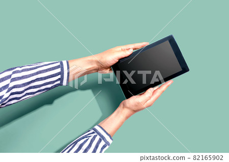 Woman using a tablet computer Woman using a tablet computer 82165902