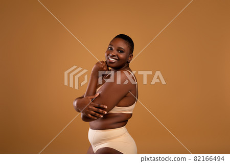 Portrait Of Curvy Smiling African American Woman In Underwear Portrait Of Curvy Smiling African American Woman In Underwear 82166494