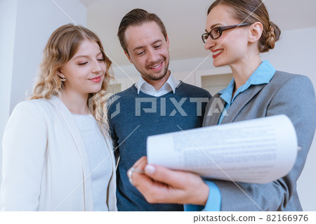Realtor lady filling in details on new lease contract for apartment Realtor lady filling in details on new lease contract for apartment 82166976