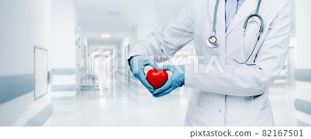 female doctor in white uniform with red heart shape with hands 82167501
