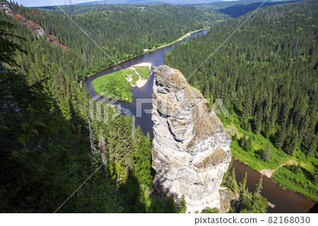 The picturesque Devil's Finger rock overlooking the Usva River. Massif Usvinskie Pillars. Perm Territory. Russia The picturesque Devil's Finger rock overlooking the Usva River. Massif Usvinskie Pillars. Perm Territory. Russia 82168030