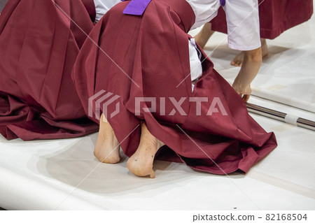 A woman performing on a calligraphy 82168504