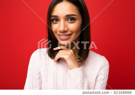 Closeup portrait of positive cheerful cute smiling young brunette woman in casual sweater isolated 82168666