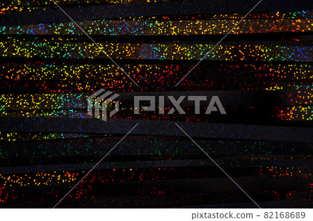 Colorful glowing rainbow drops and lights on black lined background. Colorful glowing rainbow drops and lights on black lined background. 82168689
