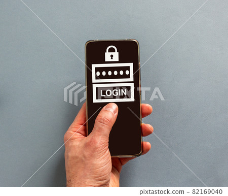 Male finger clicks on smartphone screen with a word 'login' on the blue background.  Lock sign. Concept. Copy space. 82169040