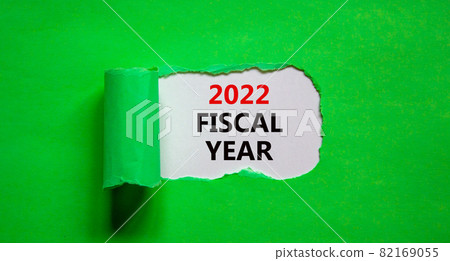 2022 fiscal new year symbol. Words '2022 fiscal year' appearing behind torn green paper. Beautiful green background. Business, 2022 fiscal new year concept, copy space. 2022 fiscal new year symbol. Words '2022 fiscal year' appearing behind torn green paper. Beautiful green background. Business, 2022 fiscal new year concept, copy space. 82169055