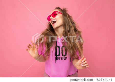 Attractive joyful happy young blonde woman wearing everyday stylish clothes and modern sunglasses Attractive joyful happy young blonde woman wearing everyday stylish clothes and modern sunglasses 82169075
