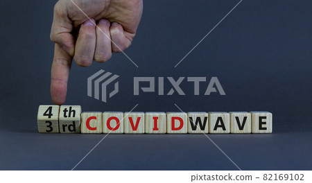 Symbol for a fourth wave of the covid-19 corona virus. Doctors turns cubes, changes words 3rd covid wave to 4th covid wave. Beautiful grey background. Fourth wave of the covid-19 concept. Copy space. Symbol for a fourth wave of the covid-19 corona virus. Doctors turns cubes, changes words 3rd covid wave to 4th covid wave. Beautiful grey background. Fourth wave of the covid-19 concept. Copy space. 82169102