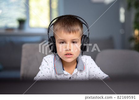 Schoolboy using laptop for studying 82169591