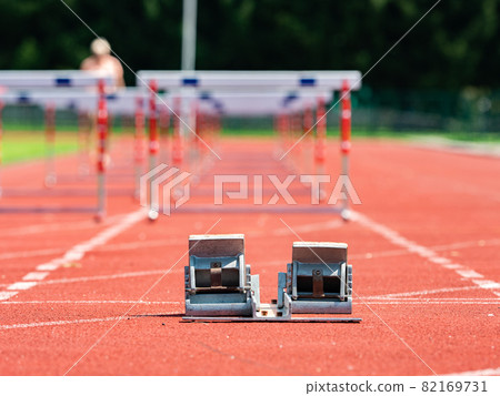 Obstacle course training. Athletics Starting Blocks and red running tracks 82169731