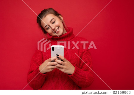Photo shot of attractive positive good looking young woman wearing casual stylish outfit poising Photo shot of attractive positive good looking young woman wearing casual stylish outfit poising 82169963