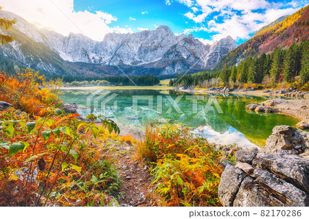 Astonishing view of Fusine lake with Mangart peak on background Astonishing view of Fusine lake with Mangart peak on background 82170286