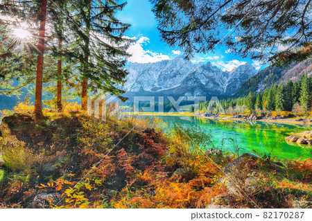 Fairytale view of Fusine lake with Mangart peak on background Fairytale view of Fusine lake with Mangart peak on background 82170287