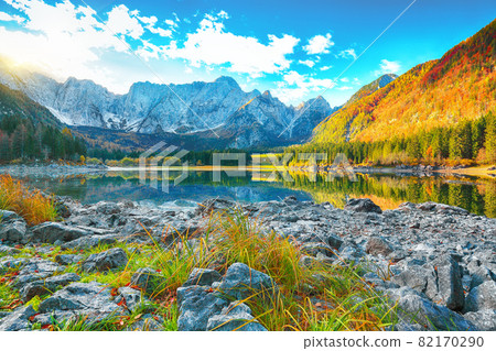 Astonishing view of Fusine lake with Mangart peak on background Astonishing view of Fusine lake with Mangart peak on background 82170290
