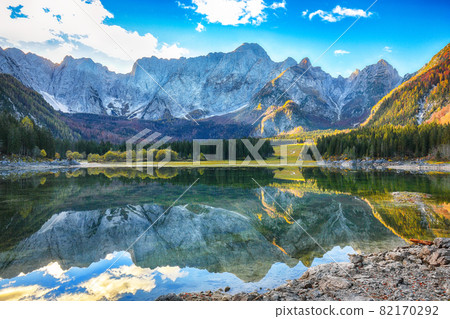 Astonishing view of Fusine lake with Mangart peak on background Astonishing view of Fusine lake with Mangart peak on background 82170292