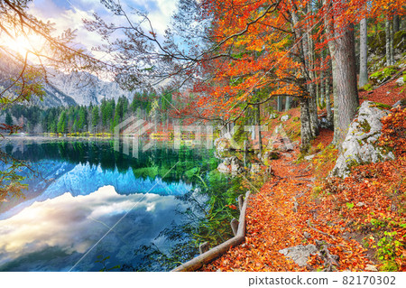 Fabulous view of sunset over Fusine lake with Mangart peak on background. Fabulous view of sunset over Fusine lake with Mangart peak on background. 82170302